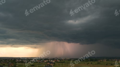 Preview: Landscape of dark clouds forming on stormy sky during thunderstorm over city rural area