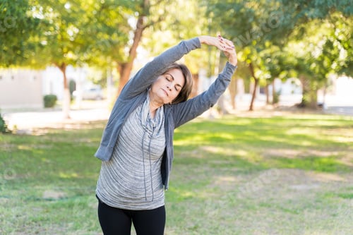 Preview: Retired Woman Doing Stretching Exercise With Eyes Closed