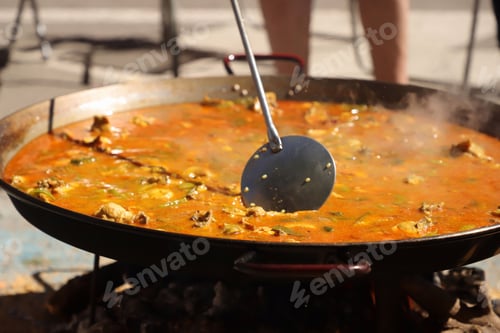 Preview: Street traditional cooking with a large stainless steel frying pan in Valencia