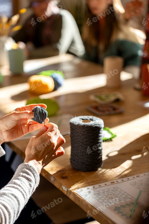Preview: Hands crafting with yarn during crochet workshop