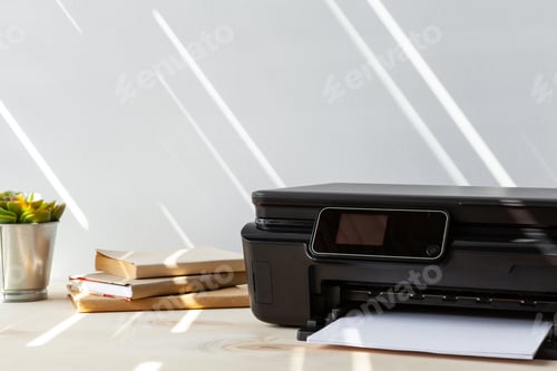 Preview: Front view of a black printer machine on a table