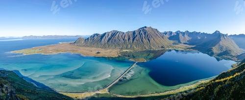 Preview: Idyllic landscape of Lofoten Islands covered by lush grassy valleys surrounded by sea waters