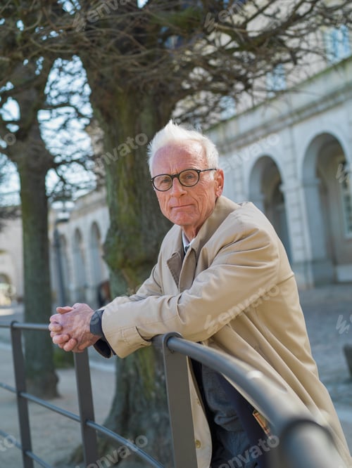 Preview: Elderly man resting on a railing outdoors