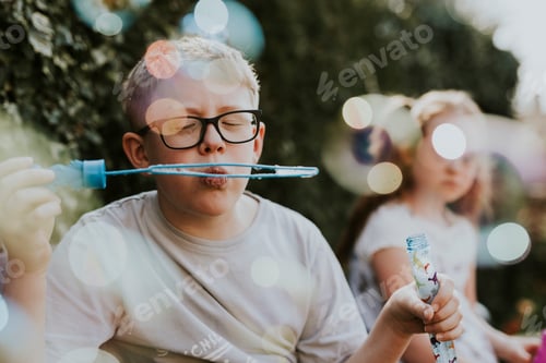 Preview: Boy blowing bubble, school holiday photo