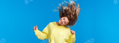 Preview: Carefree relaxed and joyful beautiful blond girl shaking head, dancing and jumping from happiness