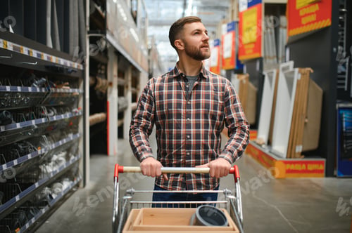 Preview: Portrait of happy mature man standing in hardware store