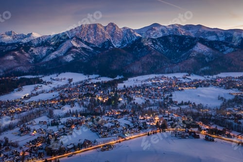 Preview: Wonderful illuminated Zakopane city after dusk in winter, aerial view