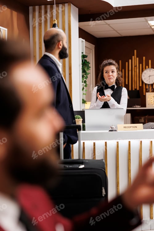 Preview: Receptionist greeting business traveller