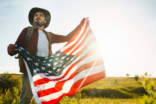 Preview: 4th of July. American Flag.Patriotic holiday. Traveler with flag of America. Beautiful sunset light.