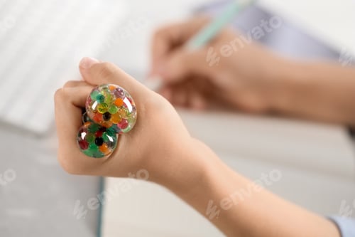 Preview: Woman squeezing colorful slime, closeup. Antistress toy