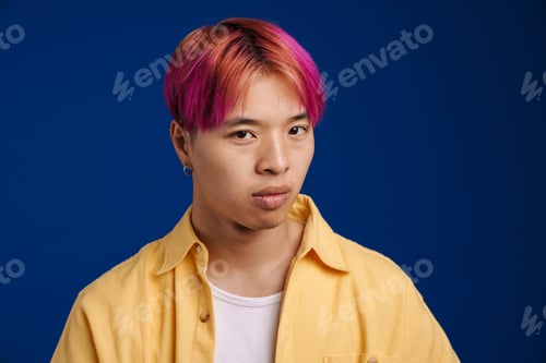 Preview: Asian boy with pink hair posing and looking at camera