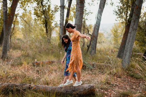 Preview: Two young women walking through the forest wearing dresses