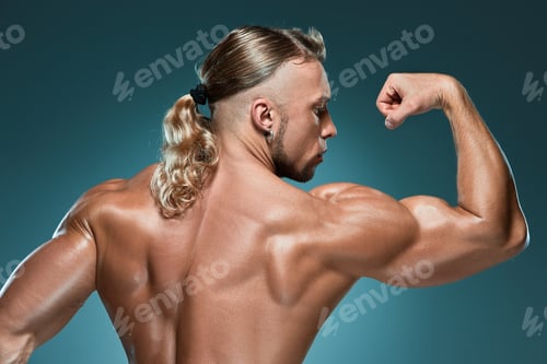 Preview: Torso Of Attractive Male Body Builder On Blue Background.