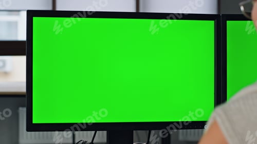 Preview: Manager working green pc screen closeup. Two chromakey monitor in home office.