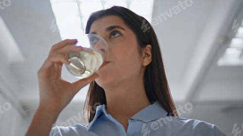 Preview: Closeup girl drinking water at lamp light. Beautiful office manager rest break