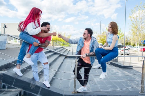 Preview: two couples greeting each other in the street