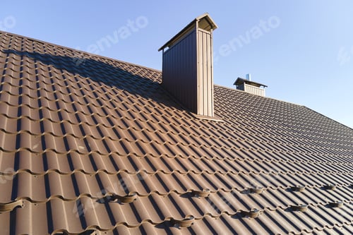 Preview: Closeup snow guard for safety in winter on house roof top covered with steel shingles.