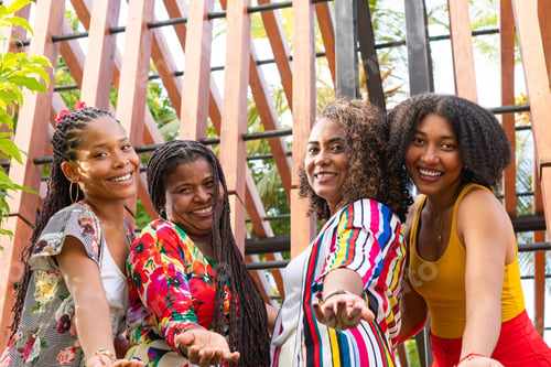 Preview: Cheerful diverse friends showing welcome gesture with hands
