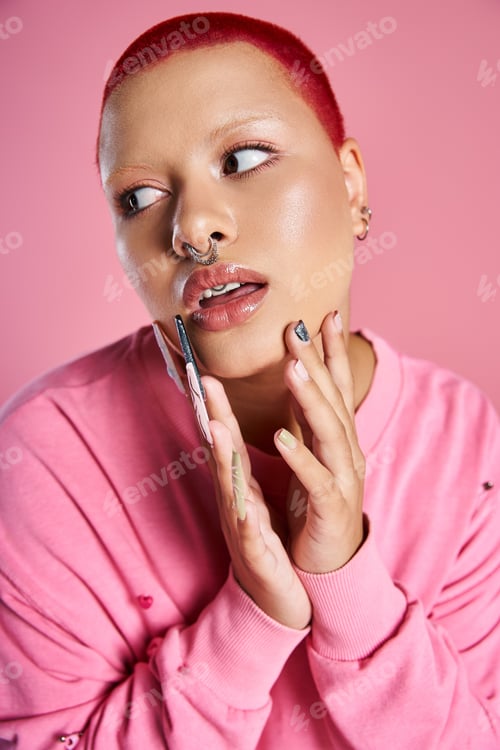 Preview: A young woman with short pink hair expressing her bold style in a vibrant studio setting