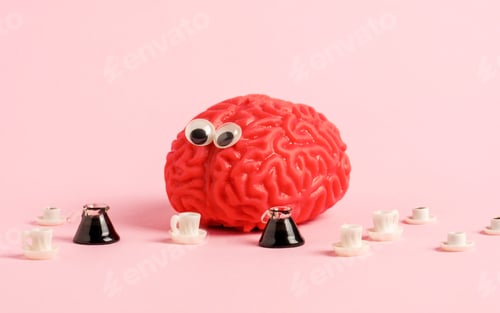Preview: Funny human brain model with googly eyes and a lot of coffee cups.
