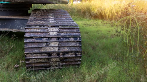 Preview: Excavator tracks. Old iron caterpillars of the bulldozer of the tractor on the road.