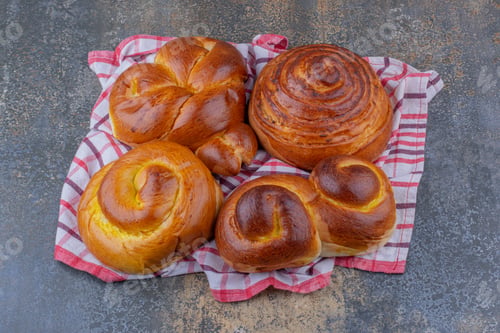 Preview: Sweet buns bundled up on a wrinkled towel on marble background