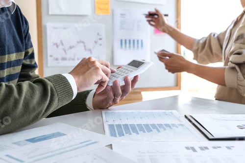 Preview: Business Colleagues Working Together on Finance Charts