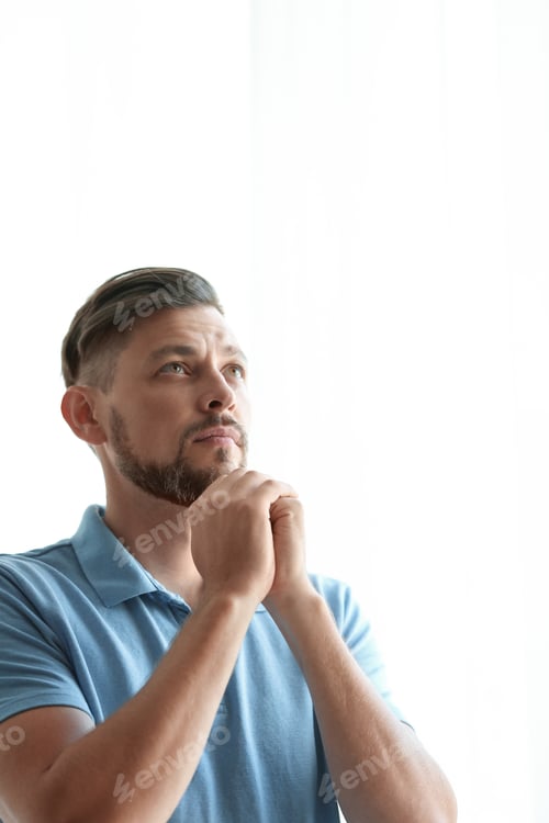 Preview: Man with hands clasped together for prayer on light background. Space for text