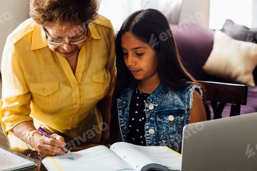 Preview: Grandmother helping granddaughter with homework