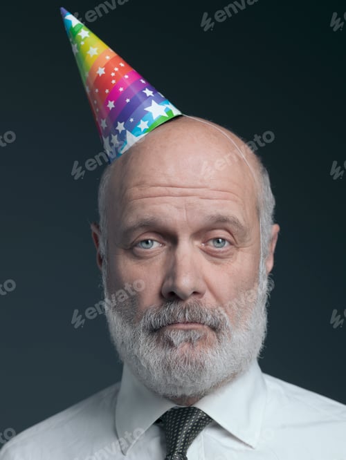 Preview: Funny senior bald man with party hat