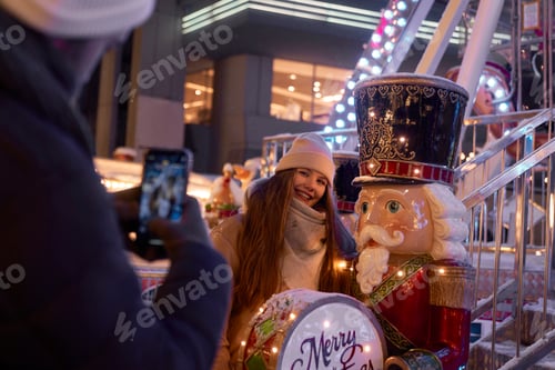 Preview: Man taking picture of his female friend during Christmas Market
