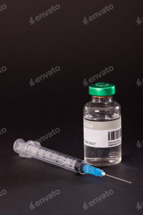Preview: Close-up of syringe and vial isolated against black background, copy space