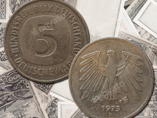 Preview: Top view of the front and back of a historic West Germany deutsche mark coin on a paper background