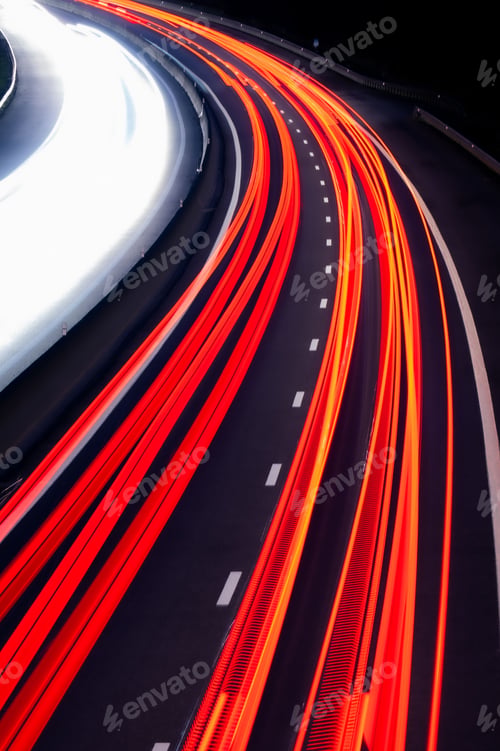 Preview: Vertical aerial view of light trails of cars on a highway road at night