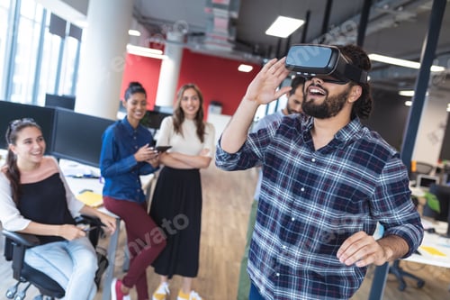 Preview: Diverse group of creative colleagues talking at meeting using vr headset
