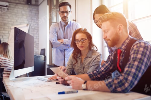 Preview: Coworkers working on project together in office
