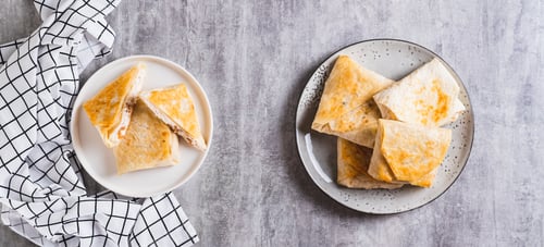Preview: Cottage cheese and apple wrapped in fried lavash on a plate on the table top view web banner