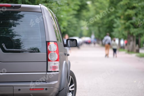 Preview: Close up of a car parked on city street side. Urban traffic concept