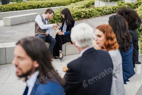 Preview: Multiethnic business people doing lunch break outdoor from office building - Focus on bottom couple