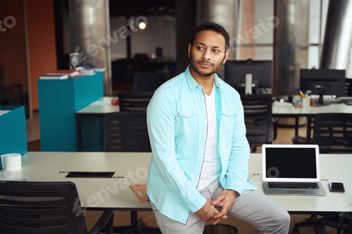 Preview: Portrait of man sitting on table at job