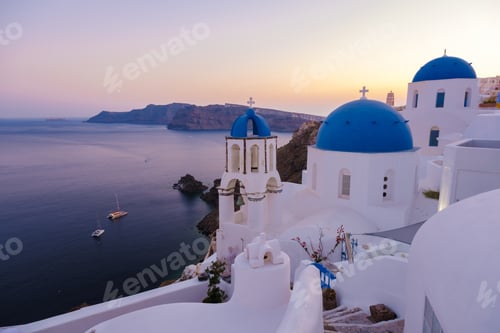Preview: White churches an blue domes by the ocean of Oia Santorini Greece, traditional Greek village