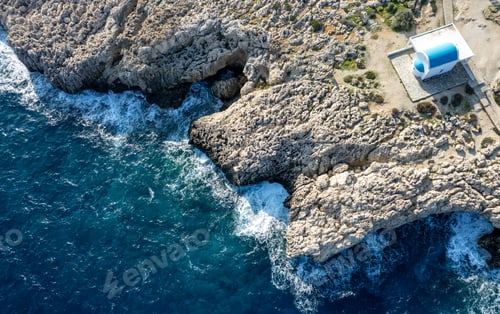 Preview: Drone aerial photograph of Cape Greko peninsula with Agioi Anargyroi white church on the rocks.