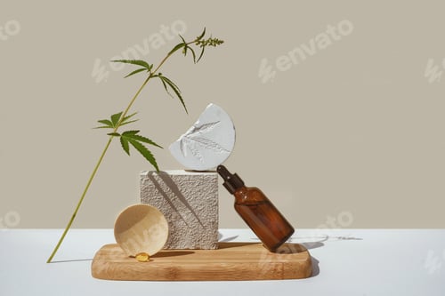Preview: CBD oil in brown bottle with dropper, cannabis branch, hemp on podium