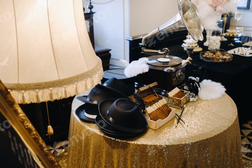 Preview: An old retro gramophone, hats and cigars are on the table
