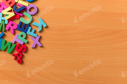 Preview: Colored alphabet letters on a wooden background. Copy space