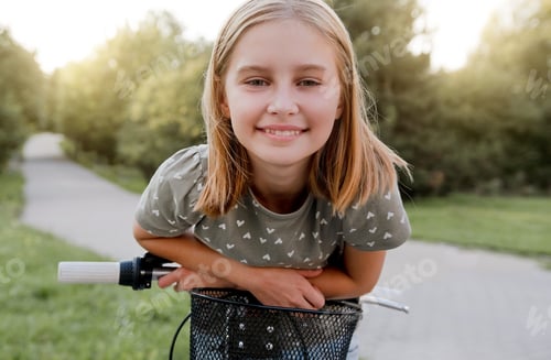Preview: Smiling Girl with Bicycle in Park