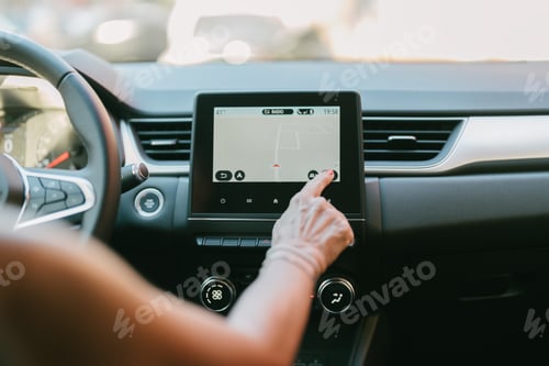 Preview: woman operating her car's navigator