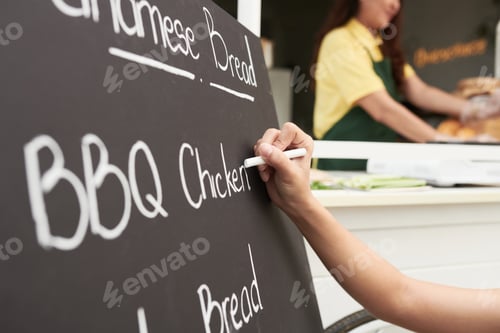 Preview: Street Food Cart Owner Writing Menu