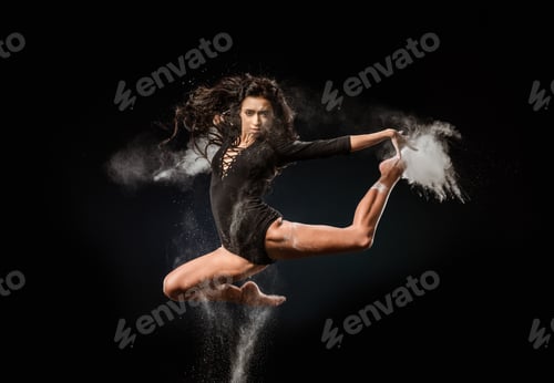 Preview: beautiful ballerina in black bodysuit with talc powder jumping on dark background