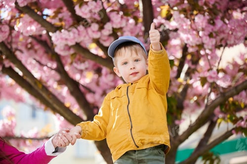 Preview: Woman allergic enjoying after treatment from seasonal allergy in front of blossom tree at spring.